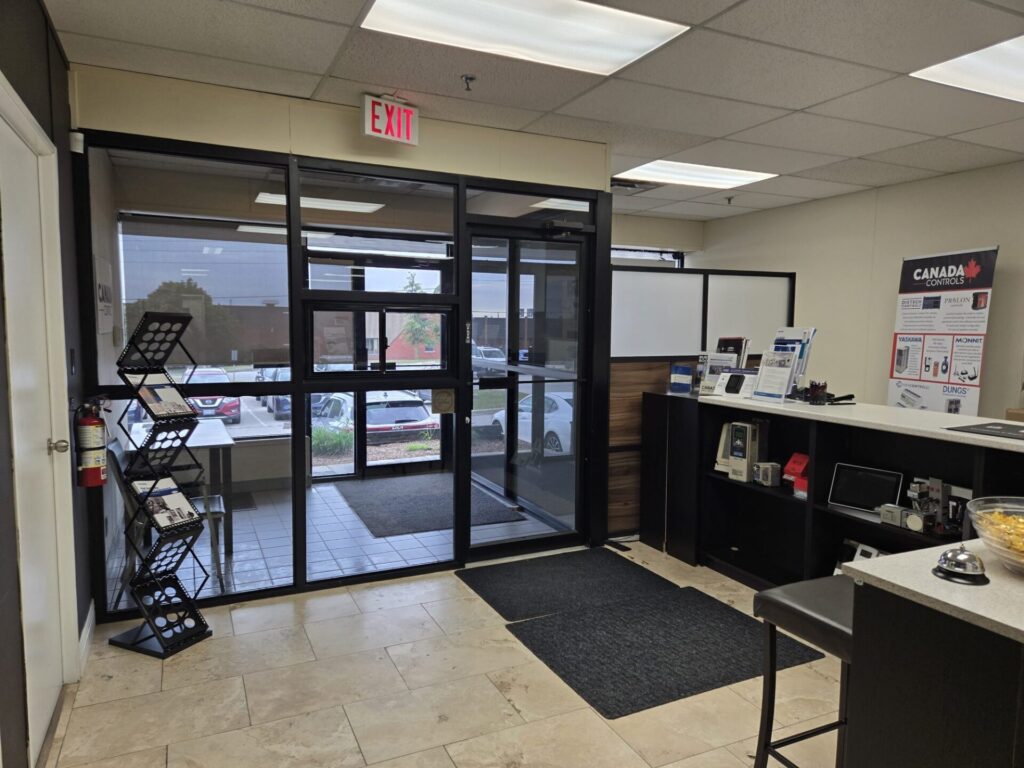 Entrance and front counter inside the Canada Controls Toronto head office and GTA branch in Mississauga, Ontario, with product literature and control device displays